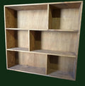 Wooden bookshelf with multiple shelves in a workshop setting