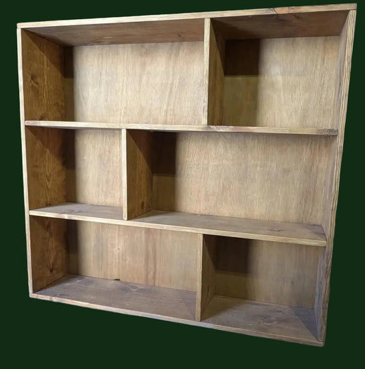 Wooden bookshelf with multiple shelves in a workshop setting